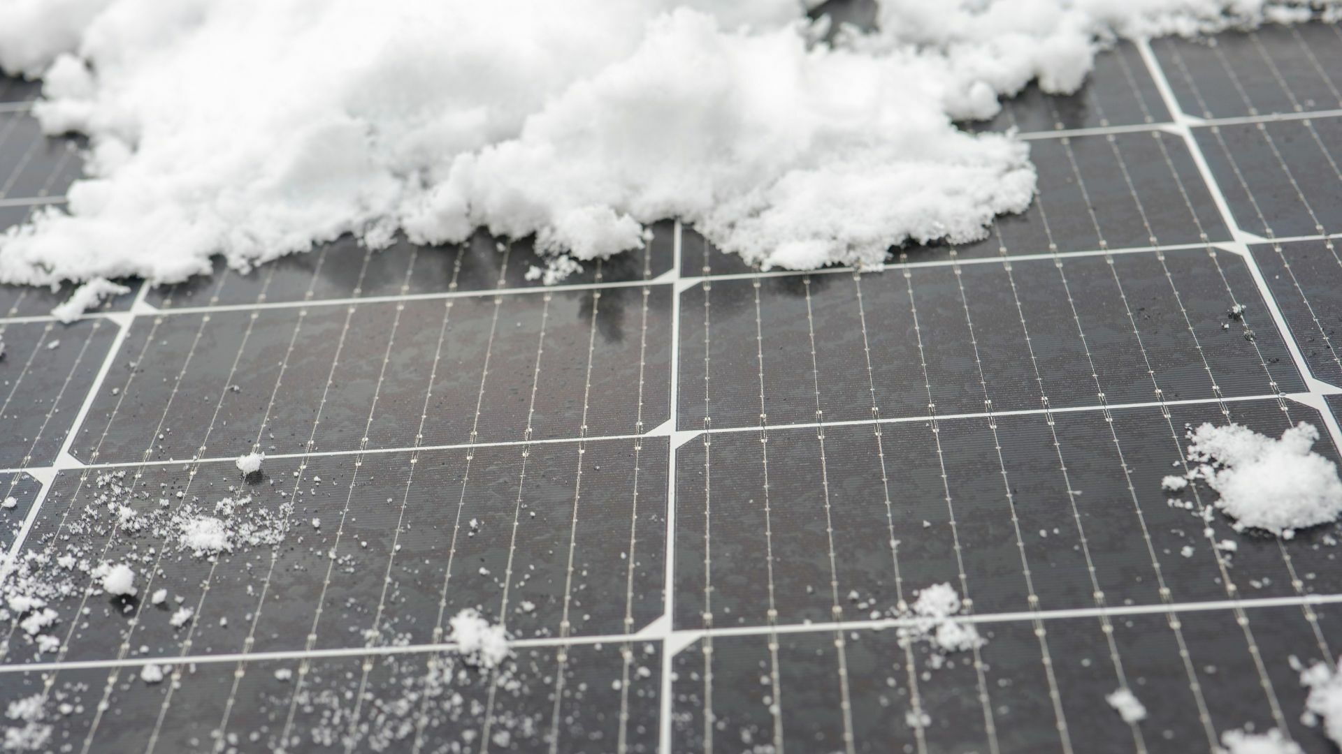 cleaning snow covered solar panels