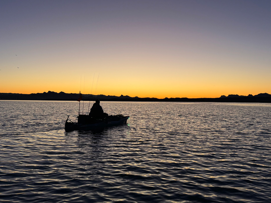 Kayak fishing at sunset