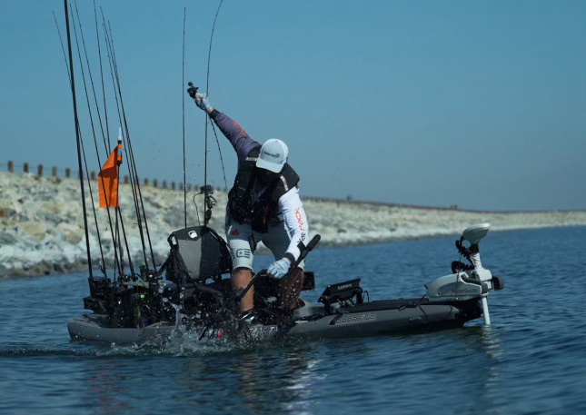 Shane LeMmon catching a fish off the coast in his kayak